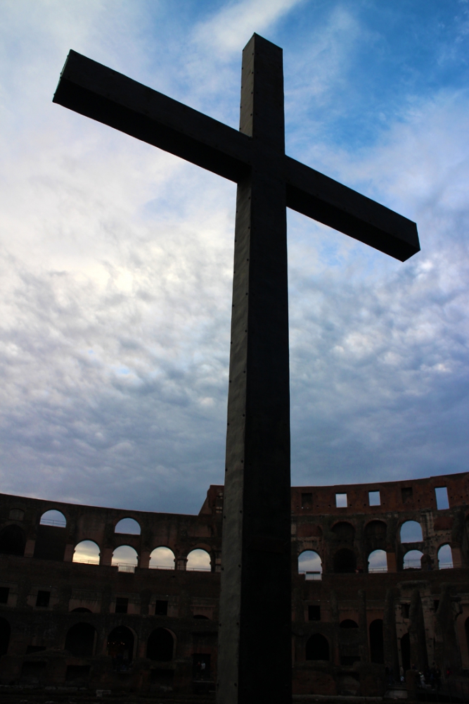 A Christian cross stands in the Colosseum